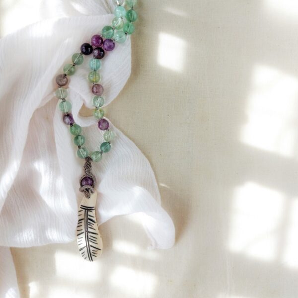 fluorite beaded necklace with macrame pendant and feather charm